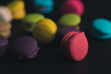 Macaroons on dark background, colorful french cookies macaroons.
