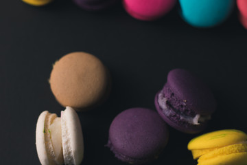 Macaroons on dark background, colorful french cookies macaroons.