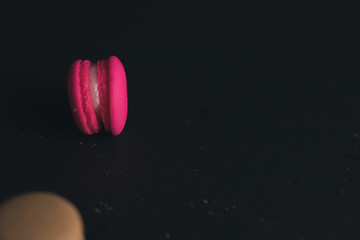 Macaroons on dark background, colorful french cookies macaroons.