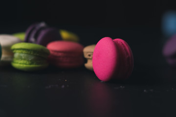 Macaroons on dark background, colorful french cookies macaroons.