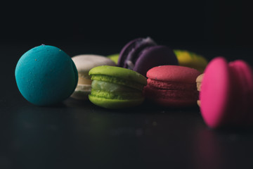 Macaroons on dark background, colorful french cookies macaroons.