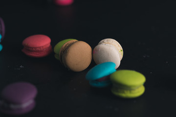 Macaroons on dark background, colorful french cookies macaroons.
