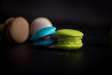 Macaroons on dark background, colorful french cookies macaroons.