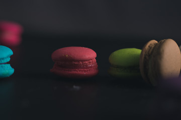 Macaroons on dark background, colorful french cookies macaroons.