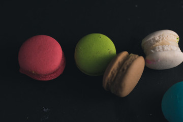 Macaroons on dark background, colorful french cookies macaroons.