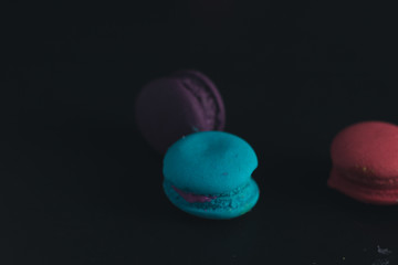 Macaroons on dark background, colorful french cookies macaroons.