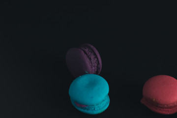 Macaroons on dark background, colorful french cookies macaroons.