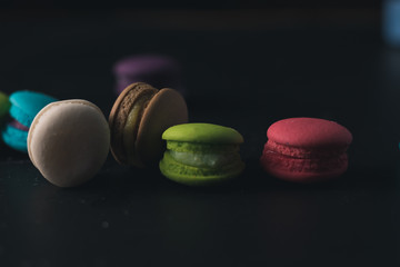 Macaroons on dark background, colorful french cookies macaroons.
