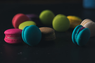 Macaroons on dark background, colorful french cookies macaroons.