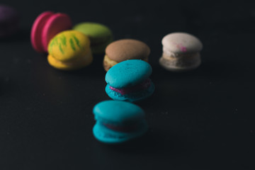 Macaroons on dark background, colorful french cookies macaroons.