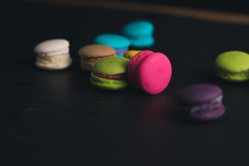 Macaroons on dark background, colorful french cookies macaroons.