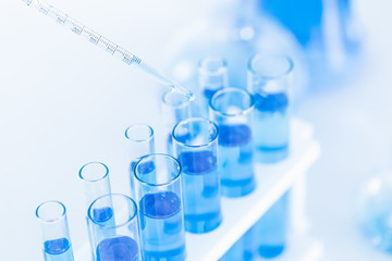 science chemical test tube with blue medical liquid inside drop test