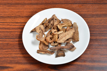 Dried porcini mushrooms on white plate