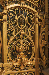 Close-up of the far-fetched golden gate decoration at the Petit Palais entrance in Paris. Known as the “City of Light”, is one of the most impressive world’s cultural center. Northern France.