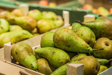green pears boxes shelves market on sale