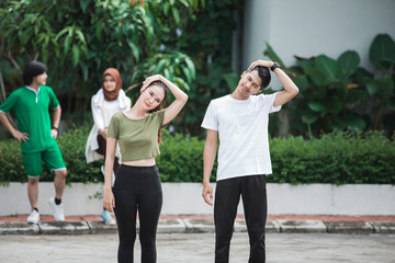 Obraz premium happy young asian people exercise and warm up