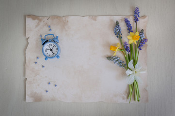 Spring time. Bouquet of daffodils and muscari flowers on a wooden background. Copy space, top view. Holiday card. Holiday background. Copy space.