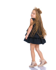 A cheerful little girl is dancing.