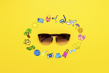 Sunglasses and Icons in Style. Travel and Vacation on a Yellow Background. Concept of Travel and Holidays. Flat lay, top view
