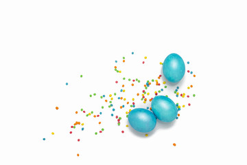 Easter Blue Eggs and Multicolored Powder on the White Background.