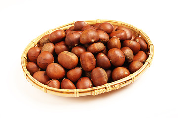 Sweet chestnuts on white background.        