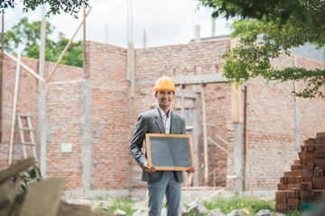 contractor holding blank black board