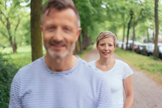 Middle-aged couple walking along a country road