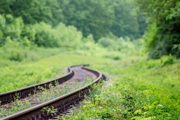 Railway track going to zigzag among picturesque nature. Travel and freight transportation_