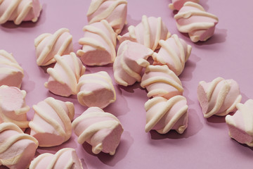 Flat lay of delicious sweet marshmallows on lilac background