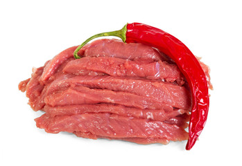Fresh meat, veal pieces and chili peppers isolated on white