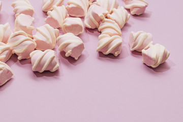 Flat lay of delicious sweet marshmallows on lilac background