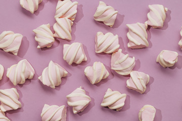 Flat lay of delicious sweet marshmallows on lilac background