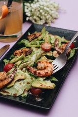 Delicious baked vegetables and shrimps on tray