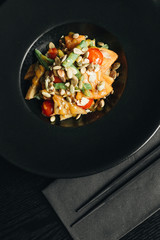 Fresh healthy dinner with seeds and vegetables on black plate