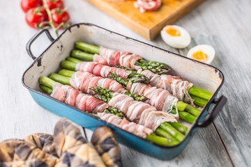 Tasty food bacon wrapped asparagus in frying pan