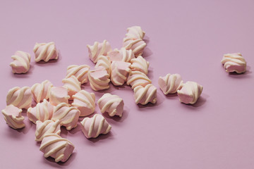 Flat lay of delicious sweet marshmallows on lilac background