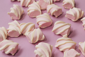 Obraz na płótnie Canvas Flat lay of delicious sweet marshmallows on lilac background