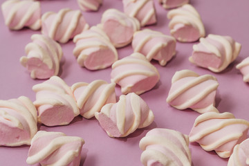 Fototapeta na wymiar Flat lay of delicious sweet marshmallows on lilac background