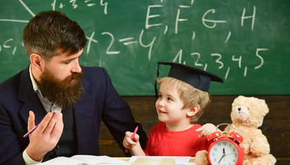 Father teaches son mathematics. Arithmetic lesson concept. Teacher in formal wear and pupil in...