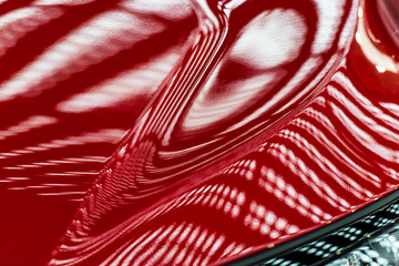 Abstraction of red metal surface of a modern car hood