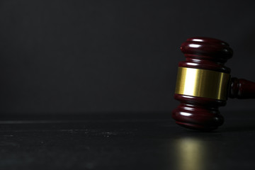 Judge gavel on black wooden background