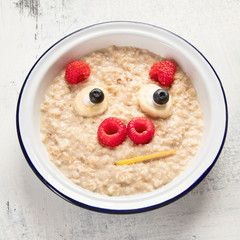 Oatmeal porridge with fruits for kids breakfast