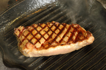 Ribeye steak in the frying pan