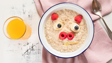 Oatmeal porridge with fruits for kids breakfast