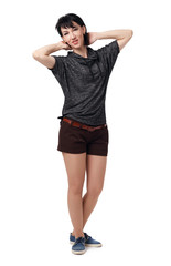 young woman posing in studio on white background, wearing brown shorts and shirt