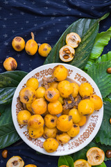 Fresh ripe mushmula or loquat fruit. Good for breakfast and desserts. Evergreen subtropical tree orange sweet and juicy fruit widely spread in Georgia, Japan, Korea, Spain and other asian countries.
