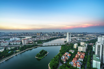 Fototapeta premium Aerial skyline view of Hanoi cityscape at twilight. Linh Dam peninsula, Hoang Mai district, Hanoi, Vietnam