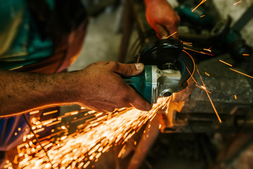 Working in the workshop cutting metal. Close-up.