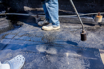Roofing installation resin with propane blowtorch using a gas burner