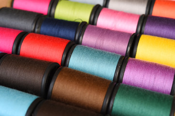 close up of colorful thread spools for background